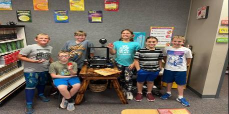 HWES 6th graders with some initial projects created on their 3-D printer.