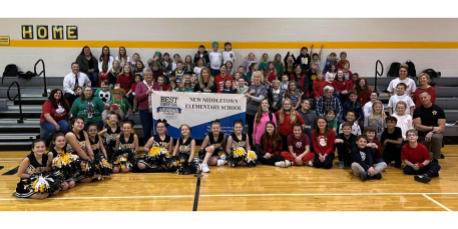 picture of teachers and students with banner
