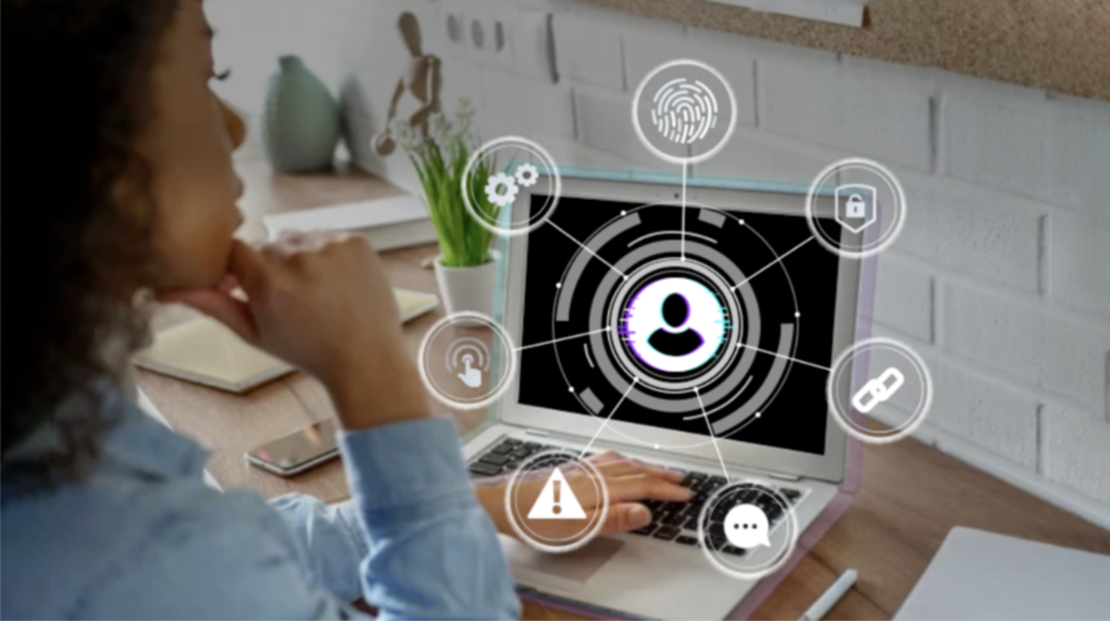 Woman looking at computer screen with safety-related icons popping off the screen