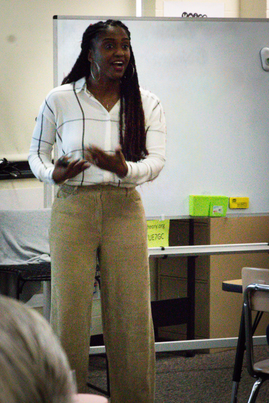 Black woman teaching at the front of the class